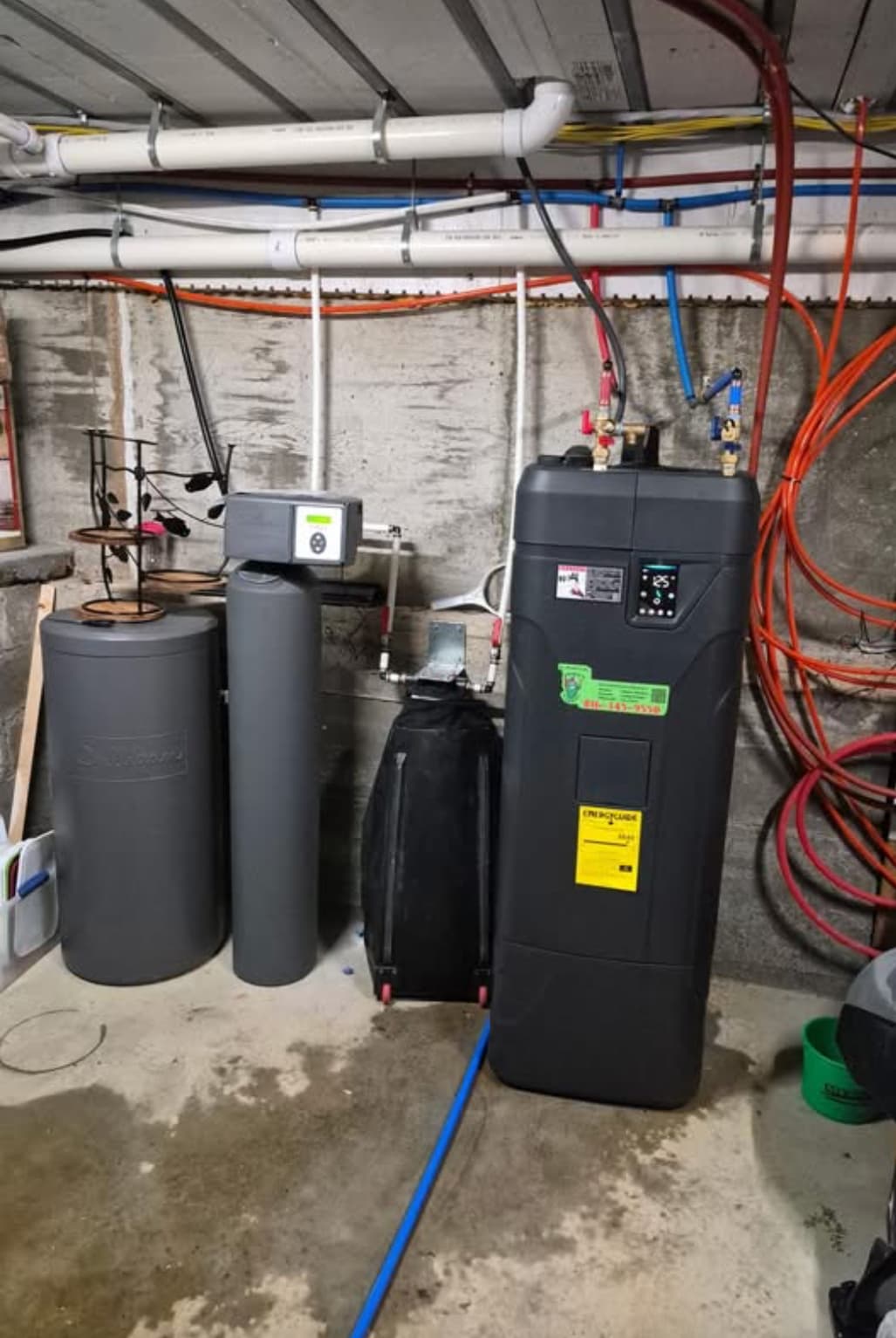 Mechanical room showing water softener and water heater — typical Leawood mechanical setup that benefits from annual maintenance